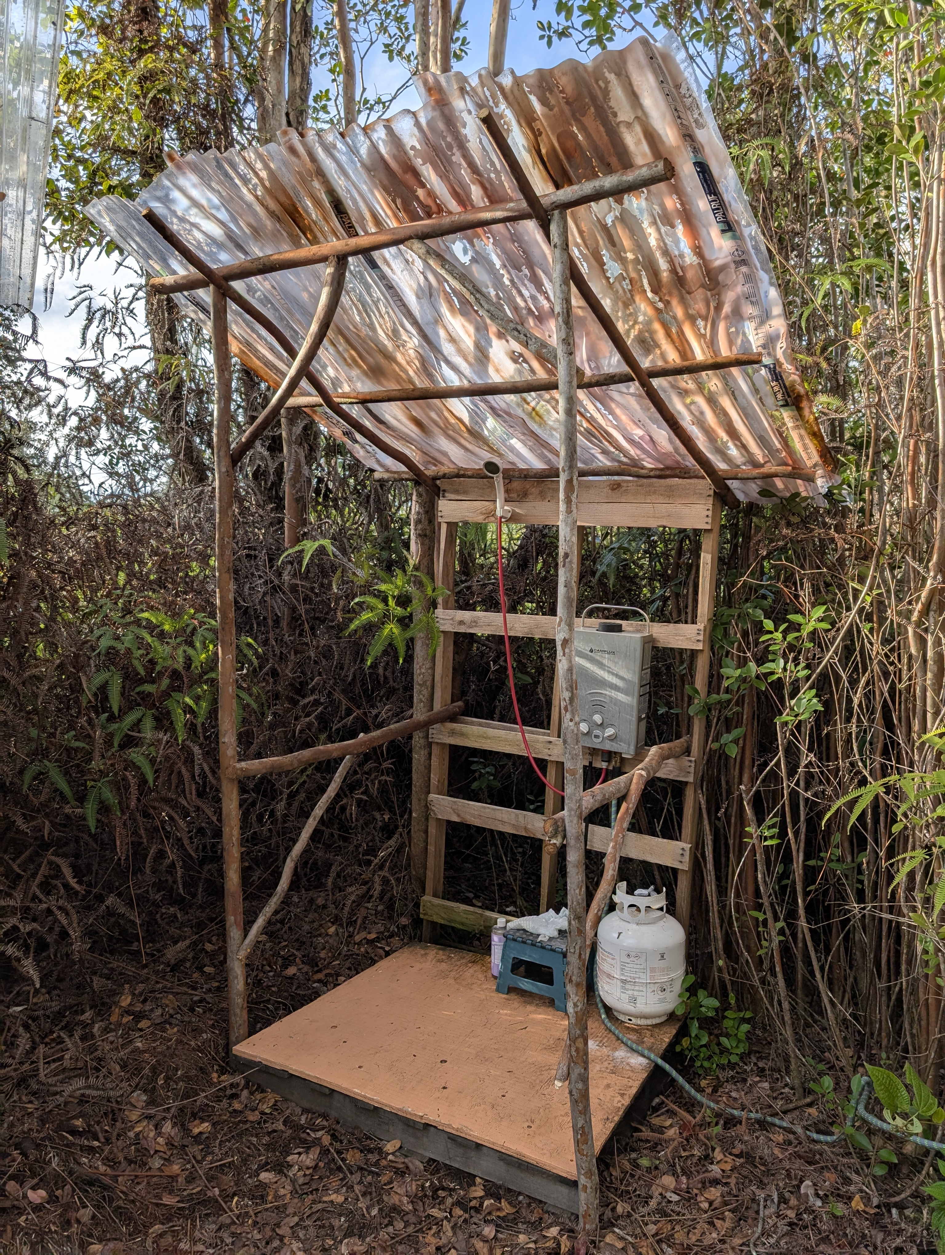 Outdoor shower with corrugated roof and propane heater
